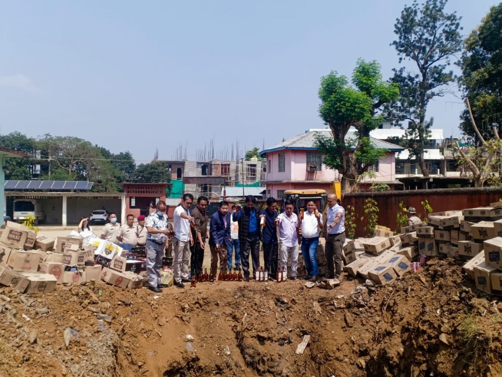 Officials and staff of Excise and Prohibition, Dimapur destroying assorted IMFL in Dimapur on March 17. (Morung Photo)